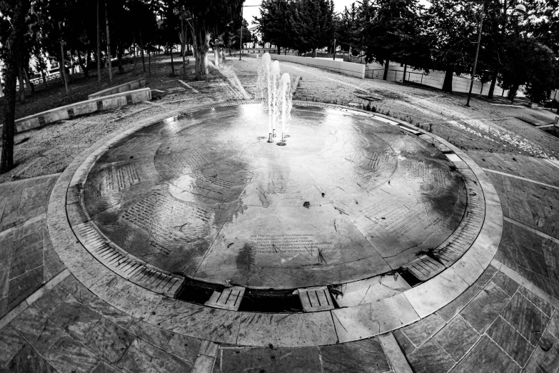 a park with a large water fountain sitting in the center