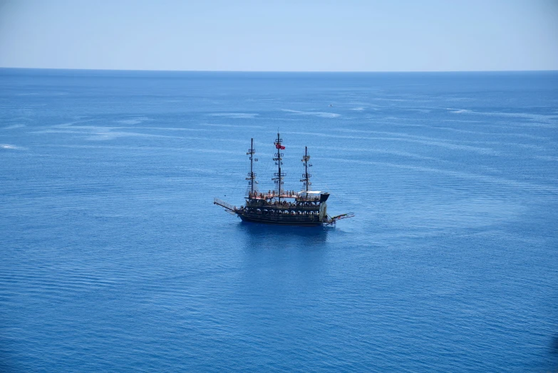 a small boat floating on top of a blue ocean