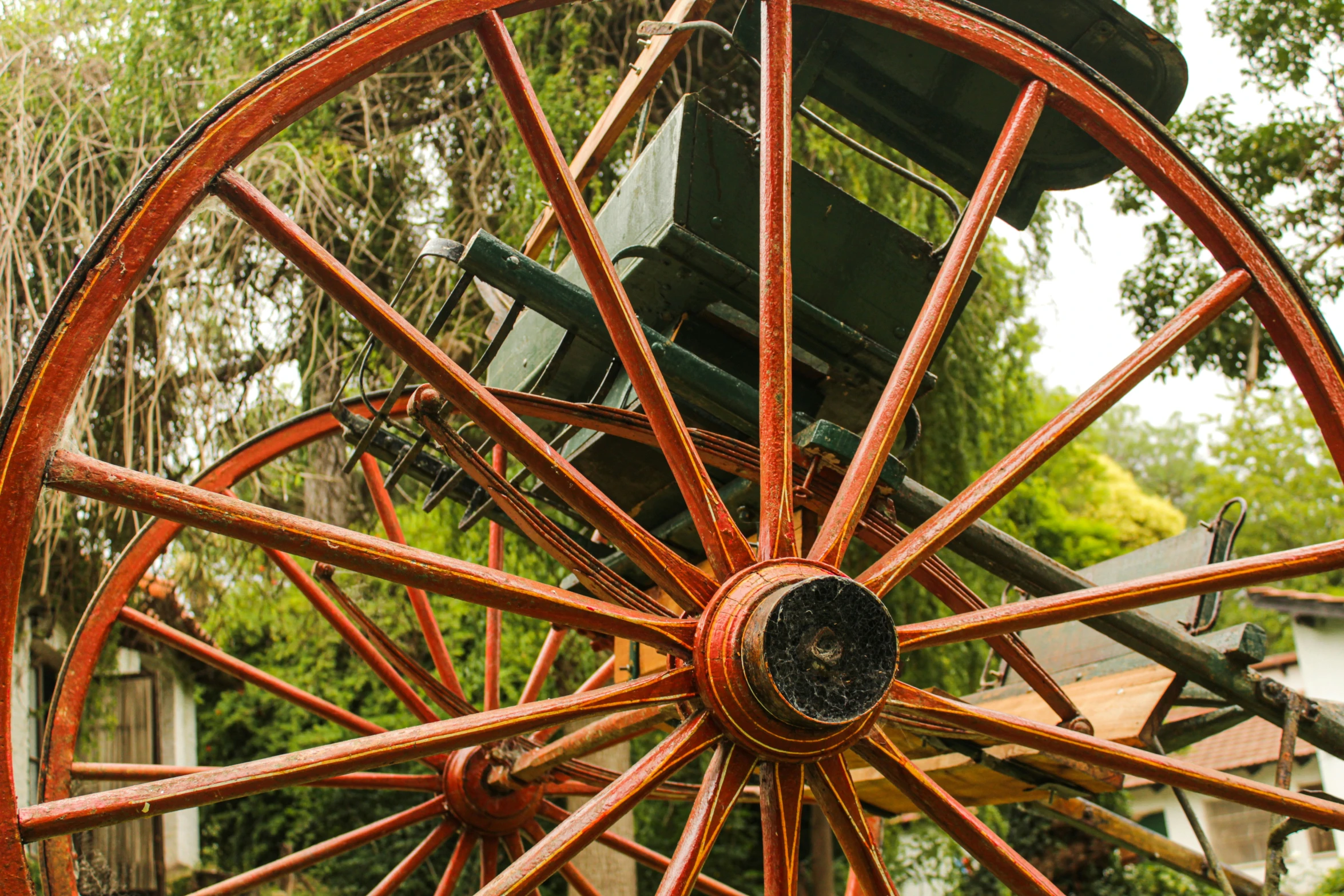 large rusted wooden wagon with wheels on display outdoors