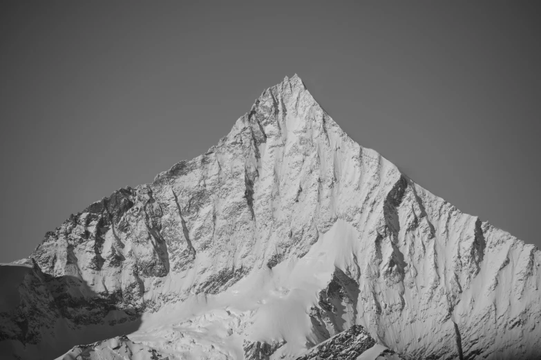 the top of a snowy mountain covered in snow