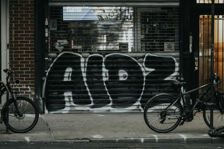 there is a bike and an old fashion bike parked in front of the store