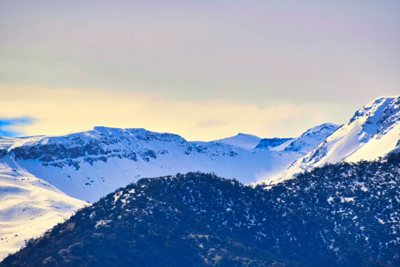 a snow covered mountain with several trees