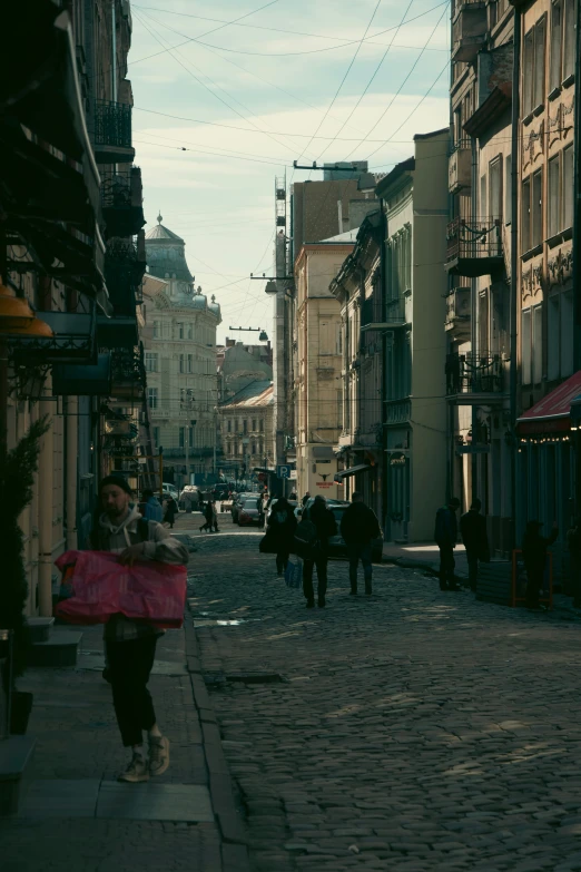 a woman walking down the street with an umbrella