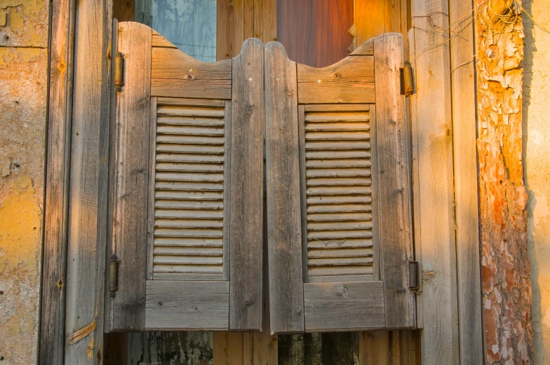 an old wooden window with shutters on the side