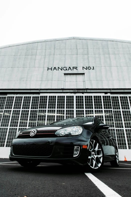 the volkswagen sports car is parked in front of a building