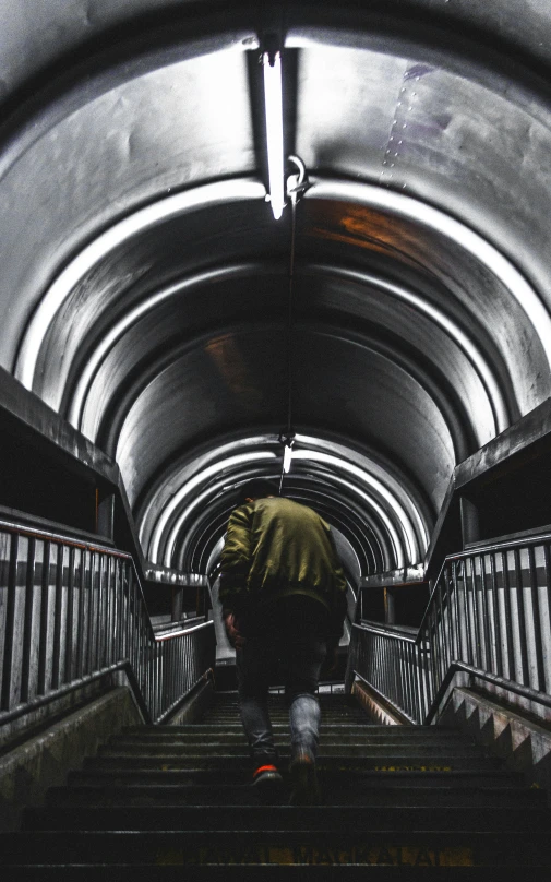 a man climbing up a flight of stairs on top of a skateboard