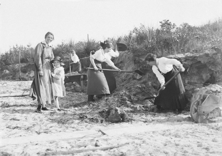 vintage women using a shovel to dig the soil