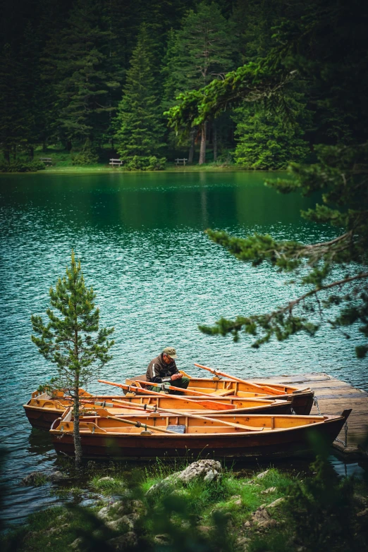 a couple of small boats sitting on top of a lake