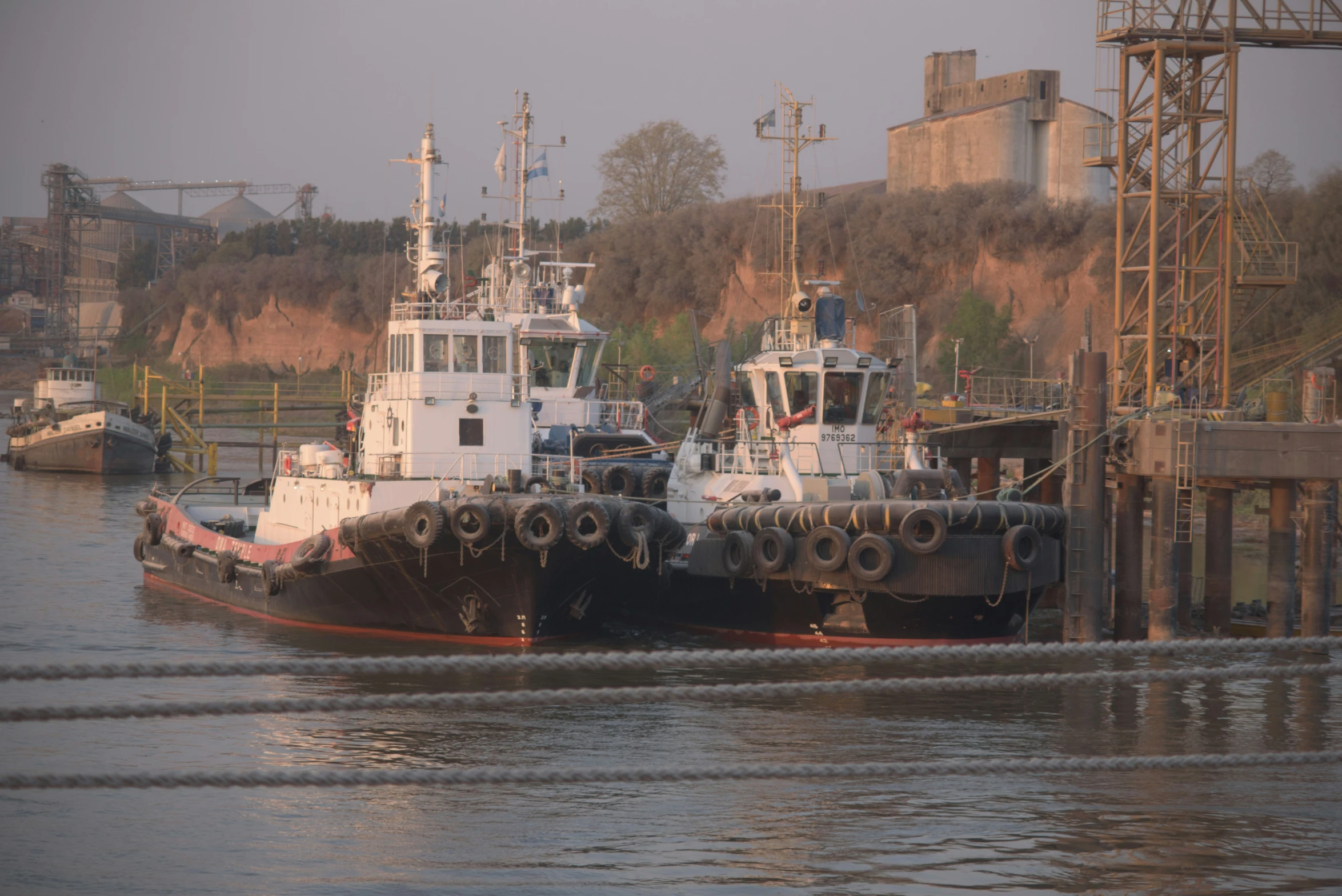 two ships tied up side by side at a dock