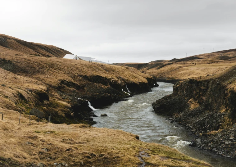 a valley has some hills that have water coming down it