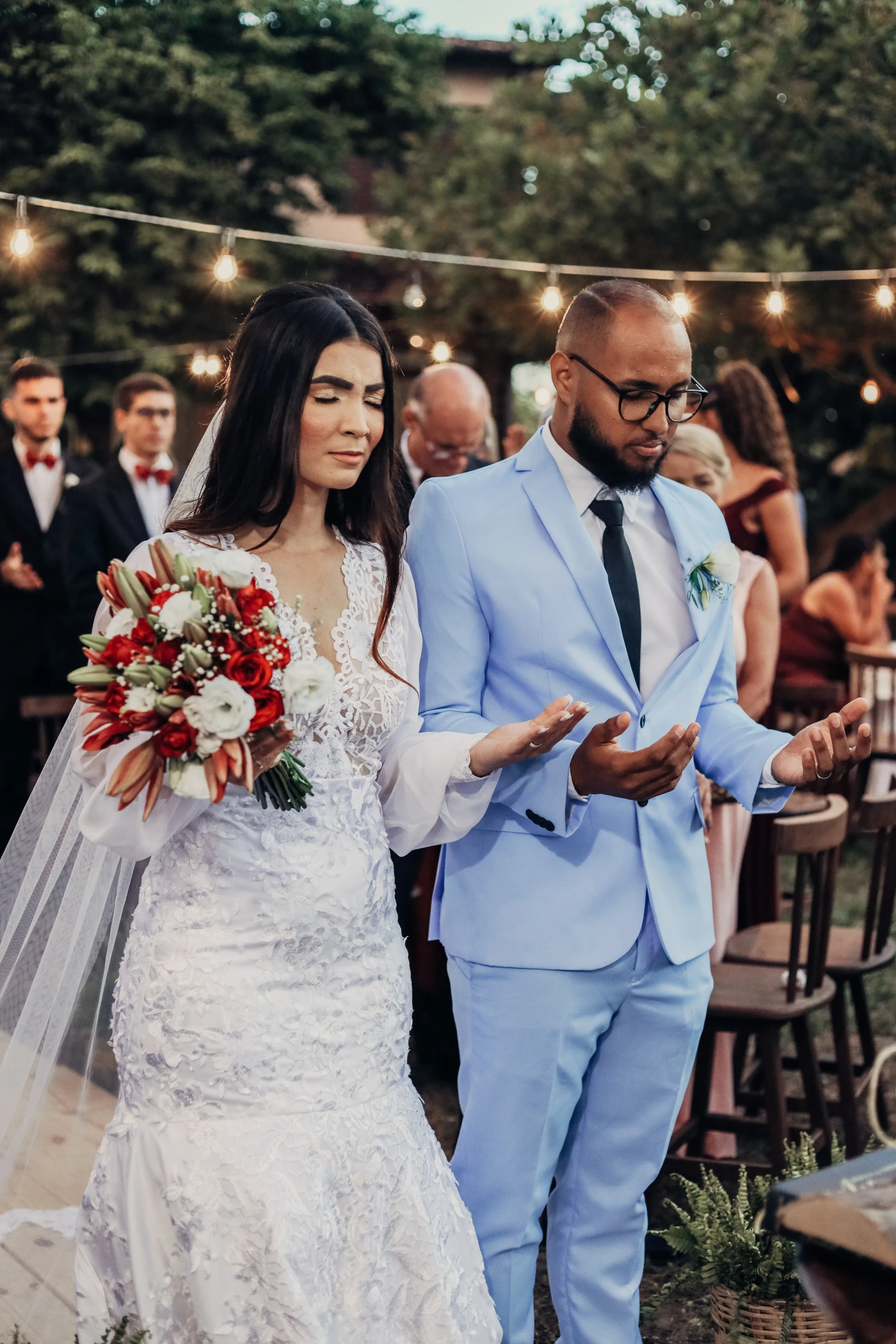 a man standing next to a woman wearing a bridal gown