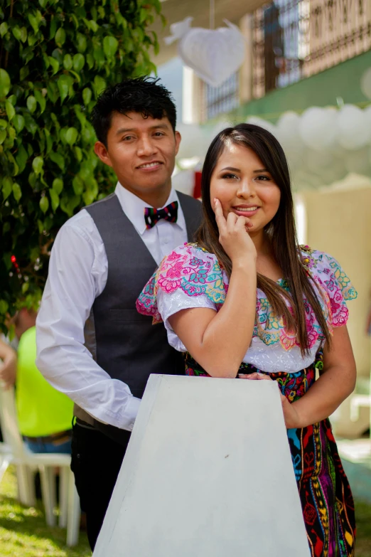 a man and woman standing in front of a sign