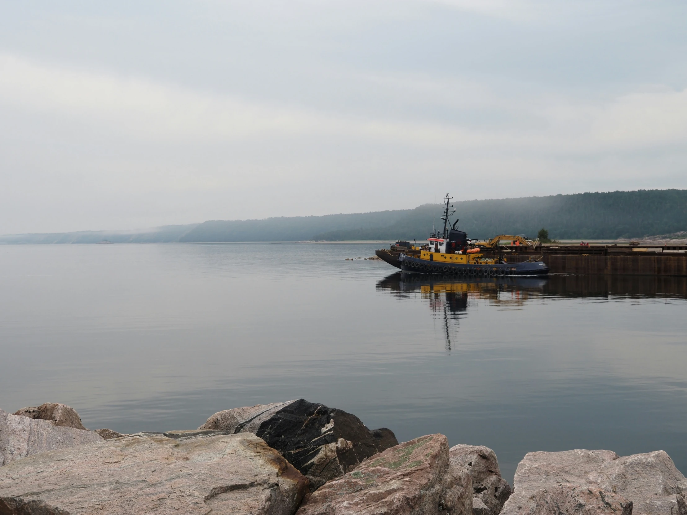 a boat in the water on a cloudy day