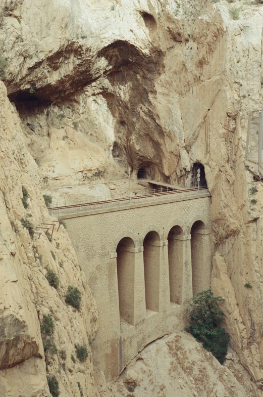 a view of a bridge and a cave