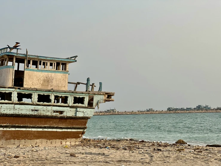 this is an old boat on the shore near water