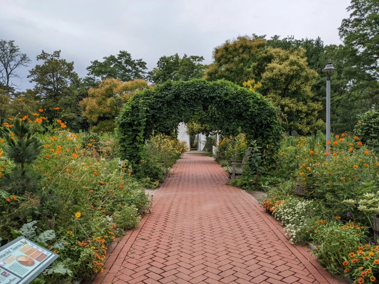 an entrance to a garden is shown with the sign showing information