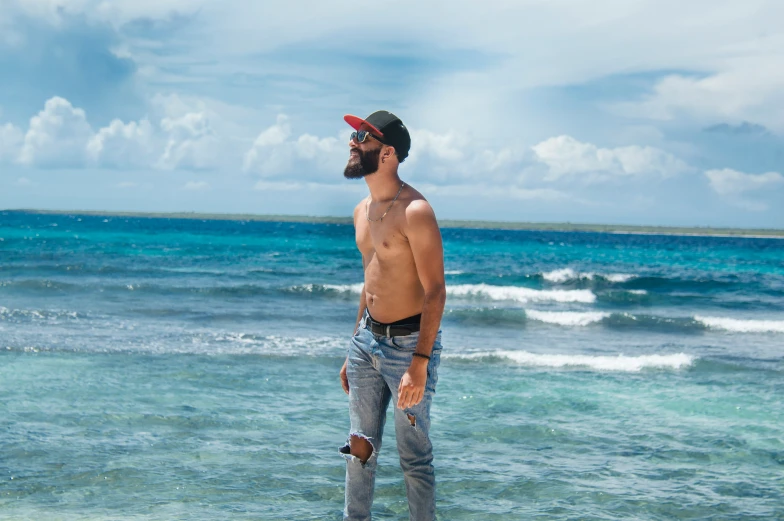 man with beard and shirtless shirt on the beach