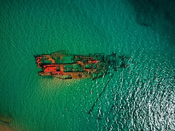 an aerial s of an ocean and ship from a helicopter