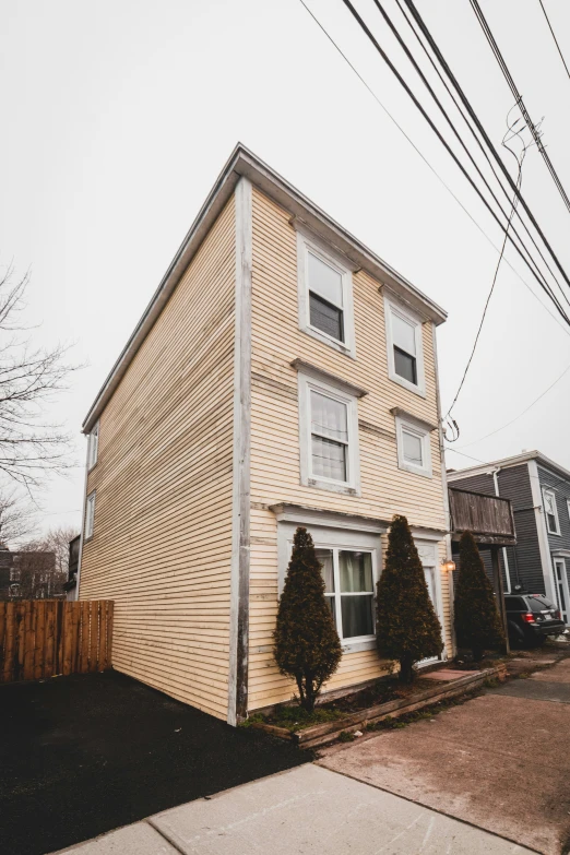 a house is shown with several cars parked next to it