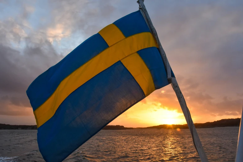 a bright blue and yellow flag on the side of a boat