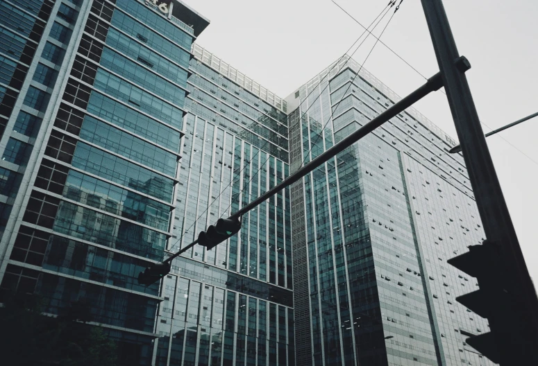 tall buildings near a street sign under a cloudy sky