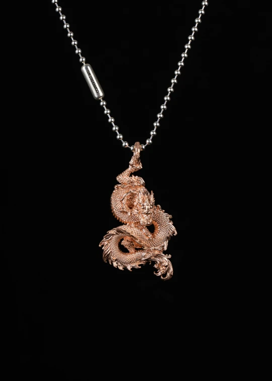 the pendant on the chain is decorated with a pink rose