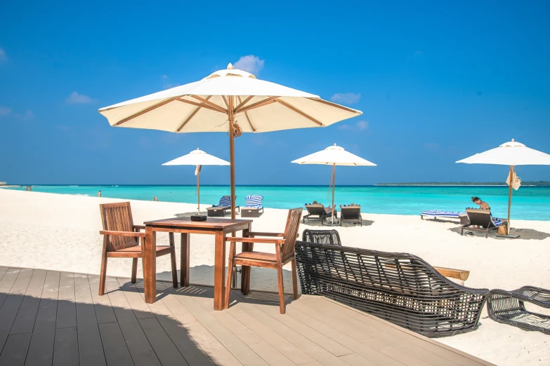 outdoor patio furniture set up on an all white beach