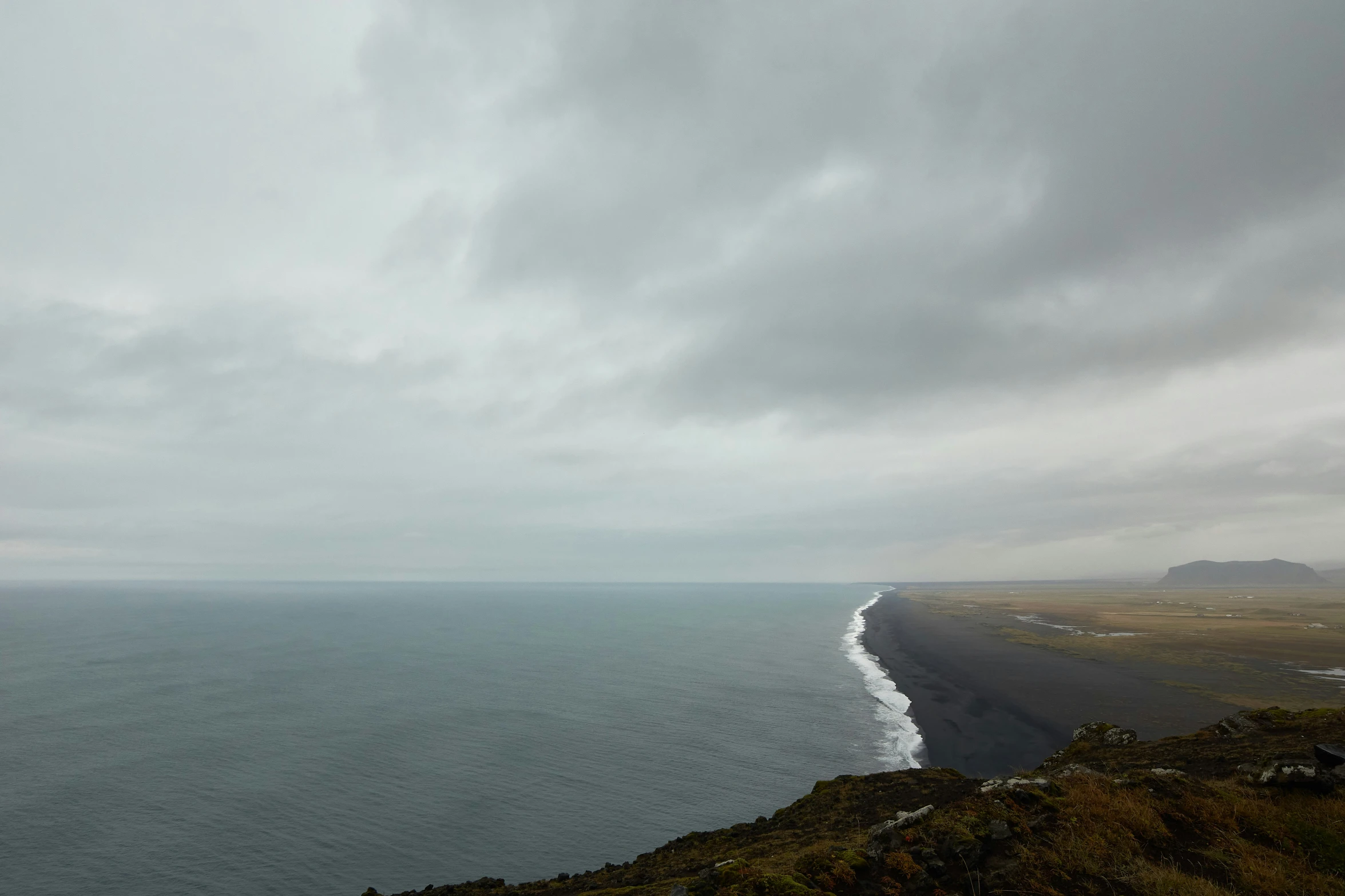 the water in the distance is calm and full of white