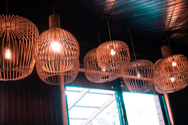 wooden lamps hanging from a ceiling made of metal