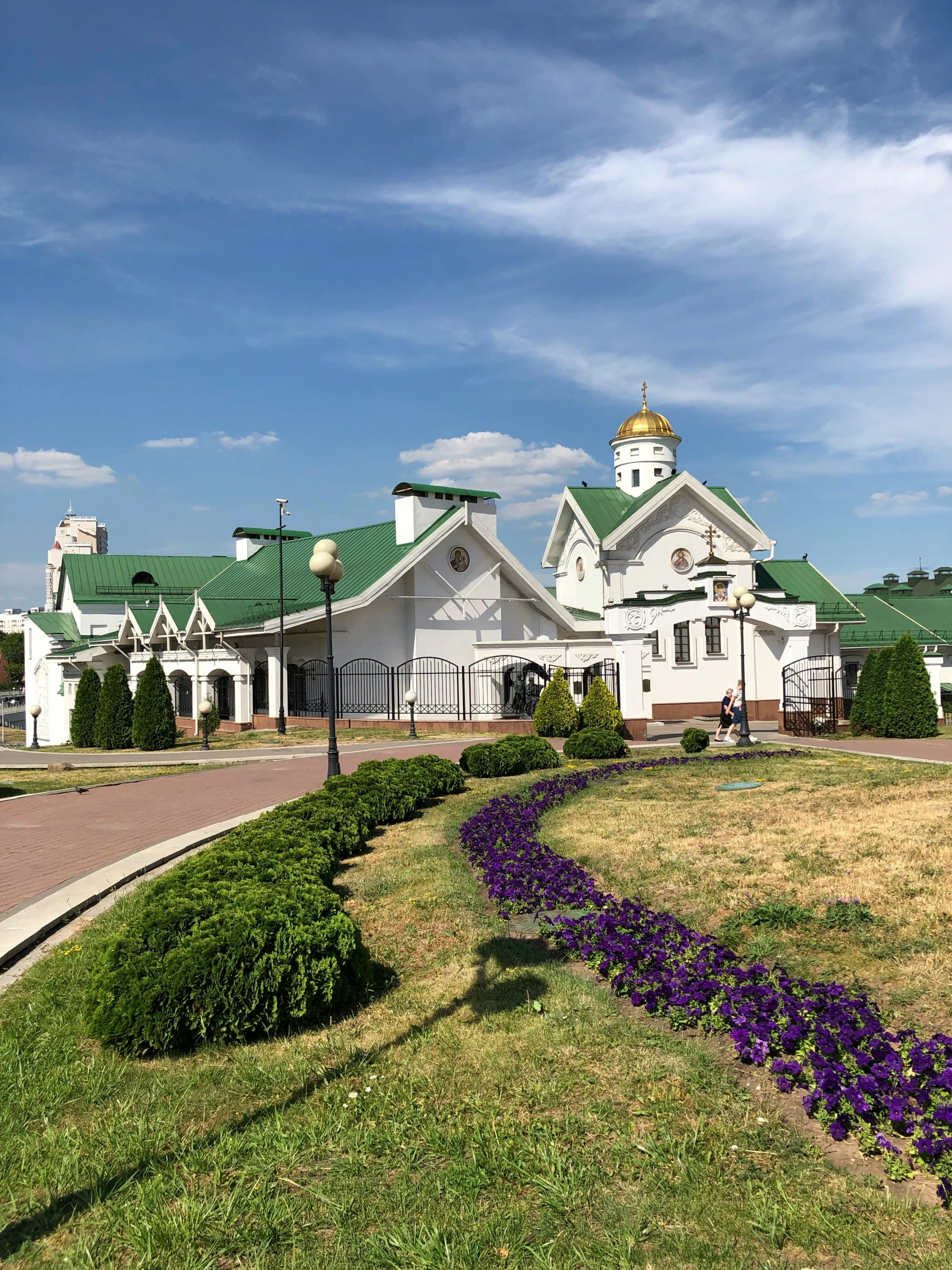 a white building with flowers on the front