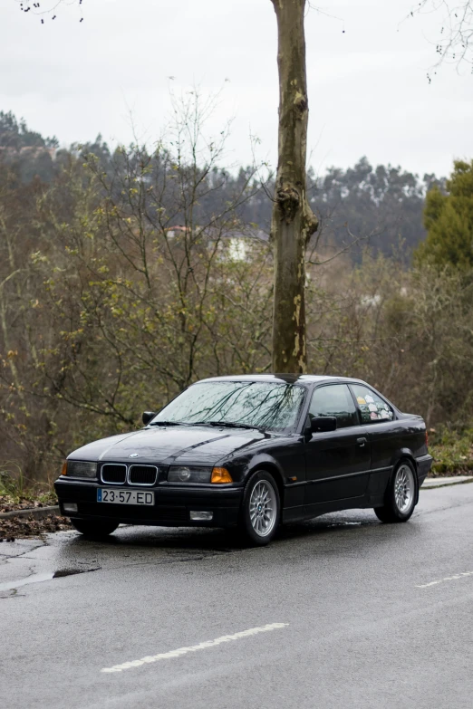 a black bmw on the side of the road