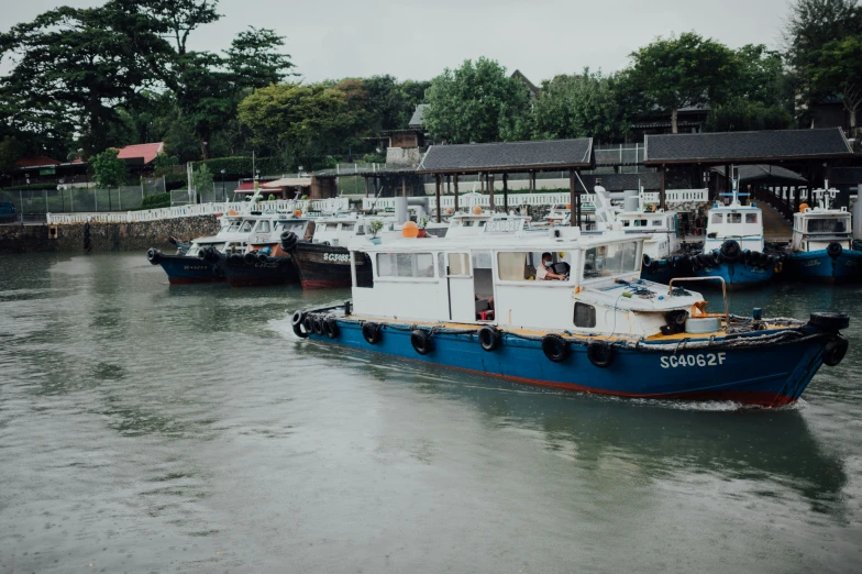 a small boat near a pier with people in it