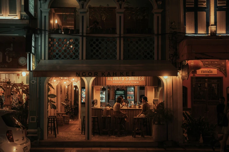 a night scene of an outside cafe and bar