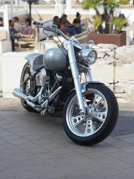 a motorcycle parked in a parking lot by a bridge