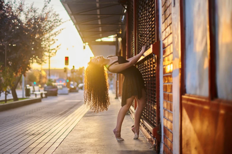 two women are kissing on a wall next to a street