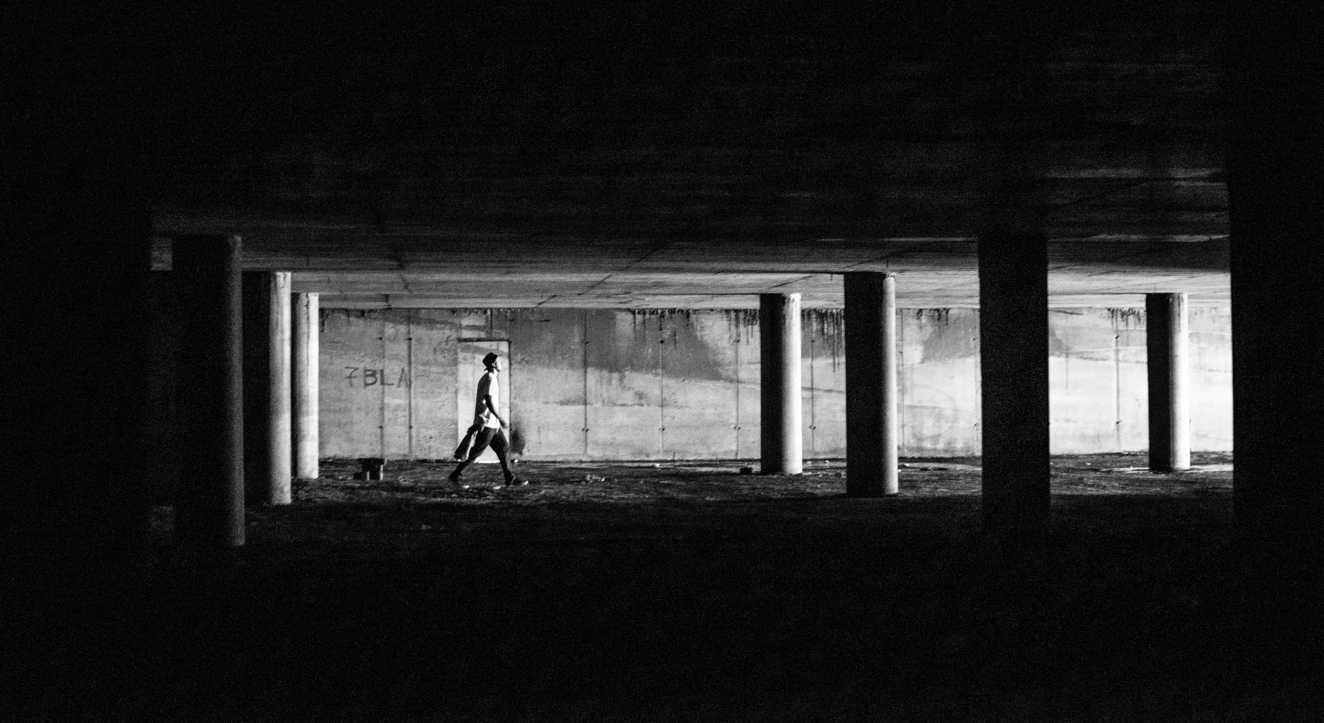 a man is walking out of an enclosed area