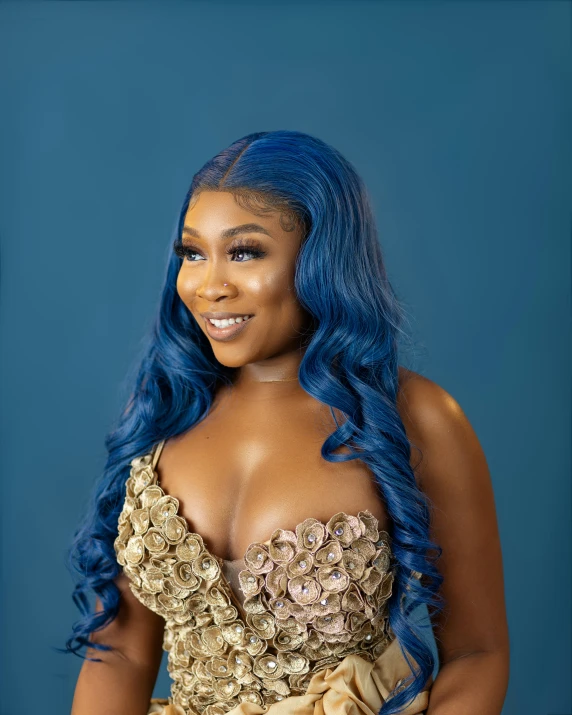 a woman with bright blue hair smiling in a dress