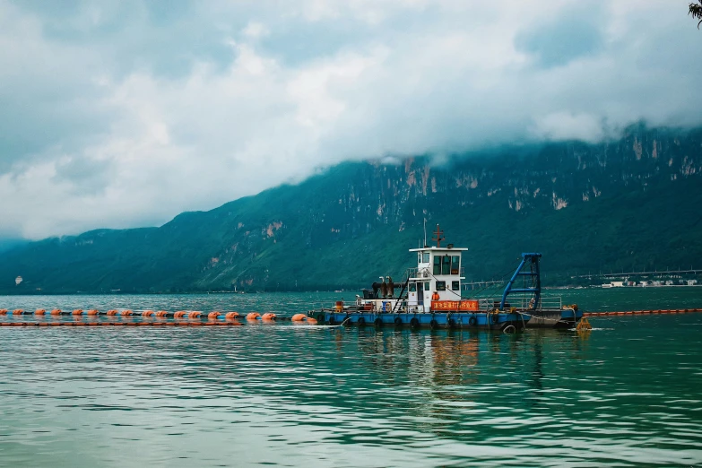 a tug boat with mooring nets on the water