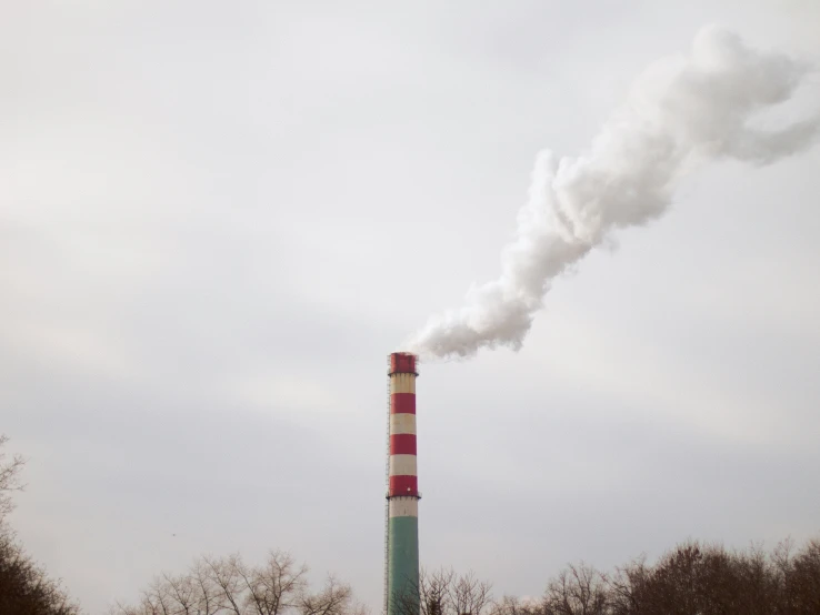 smoke billowing from the top of a chimney