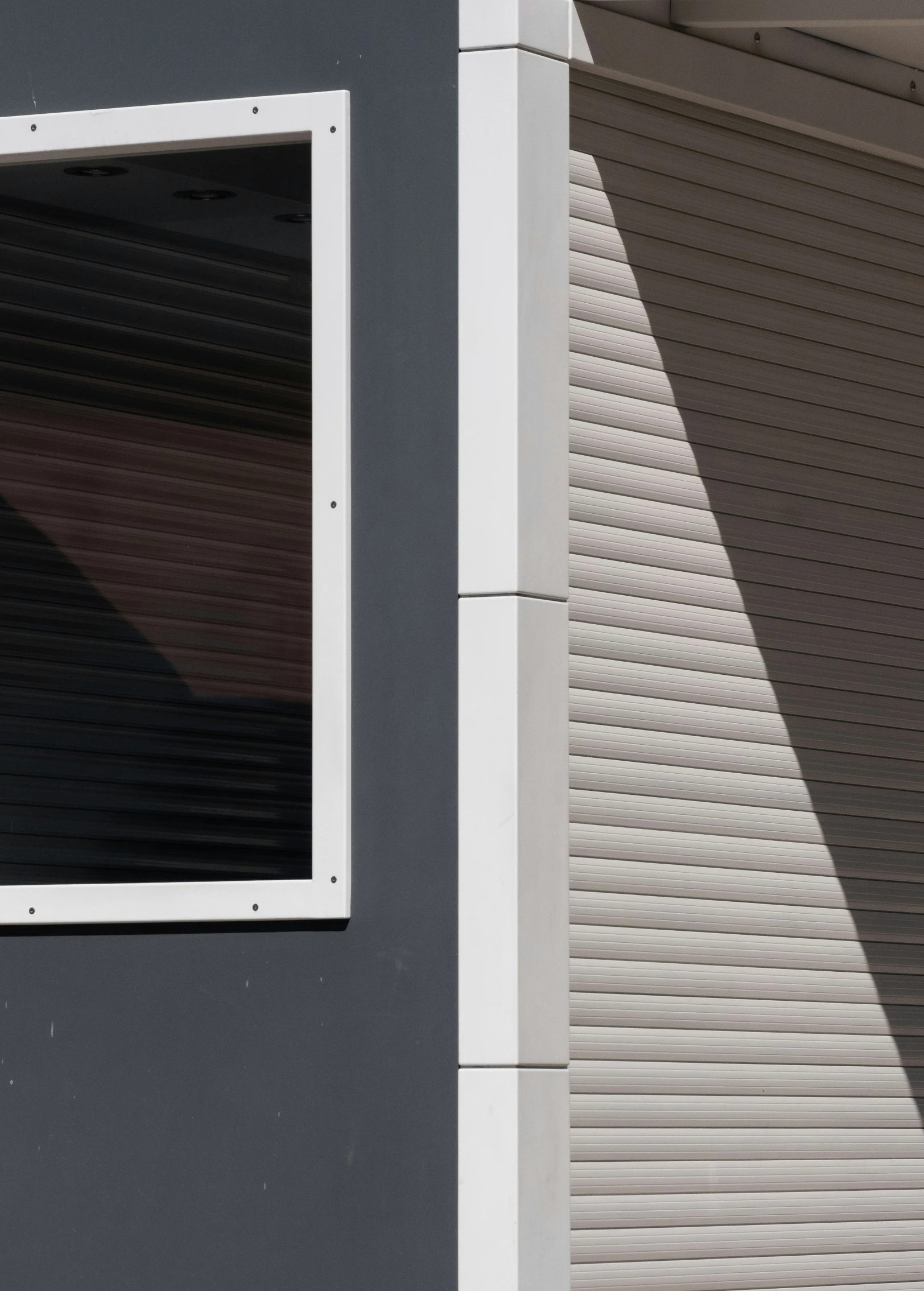 a building with several metal shutters near it