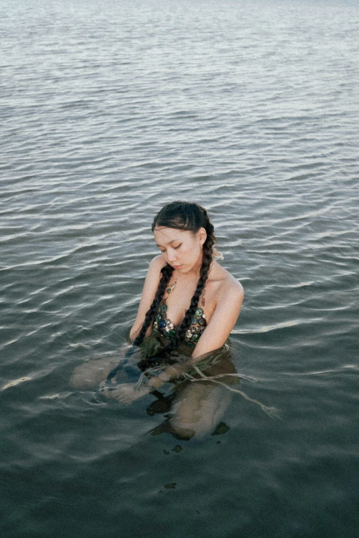 a woman in a bathing suit sitting in the water