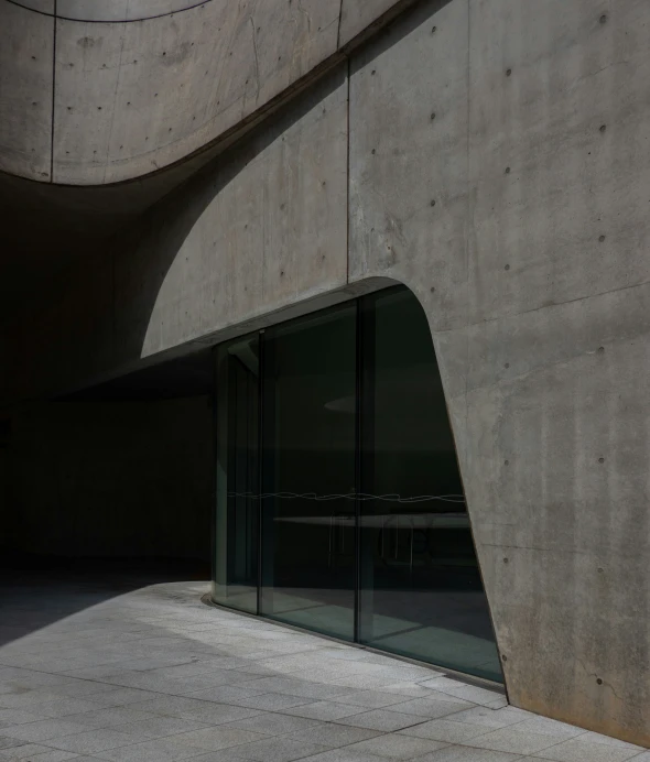 a concrete wall with an abstract pattern, glass doors and black frames