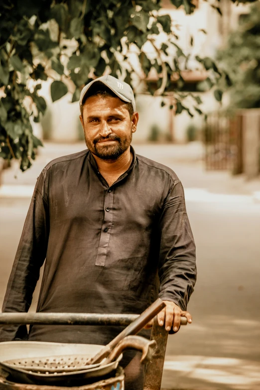 a man is standing next to his cart on the sidewalk