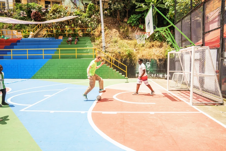 several people are playing on a court with many colors