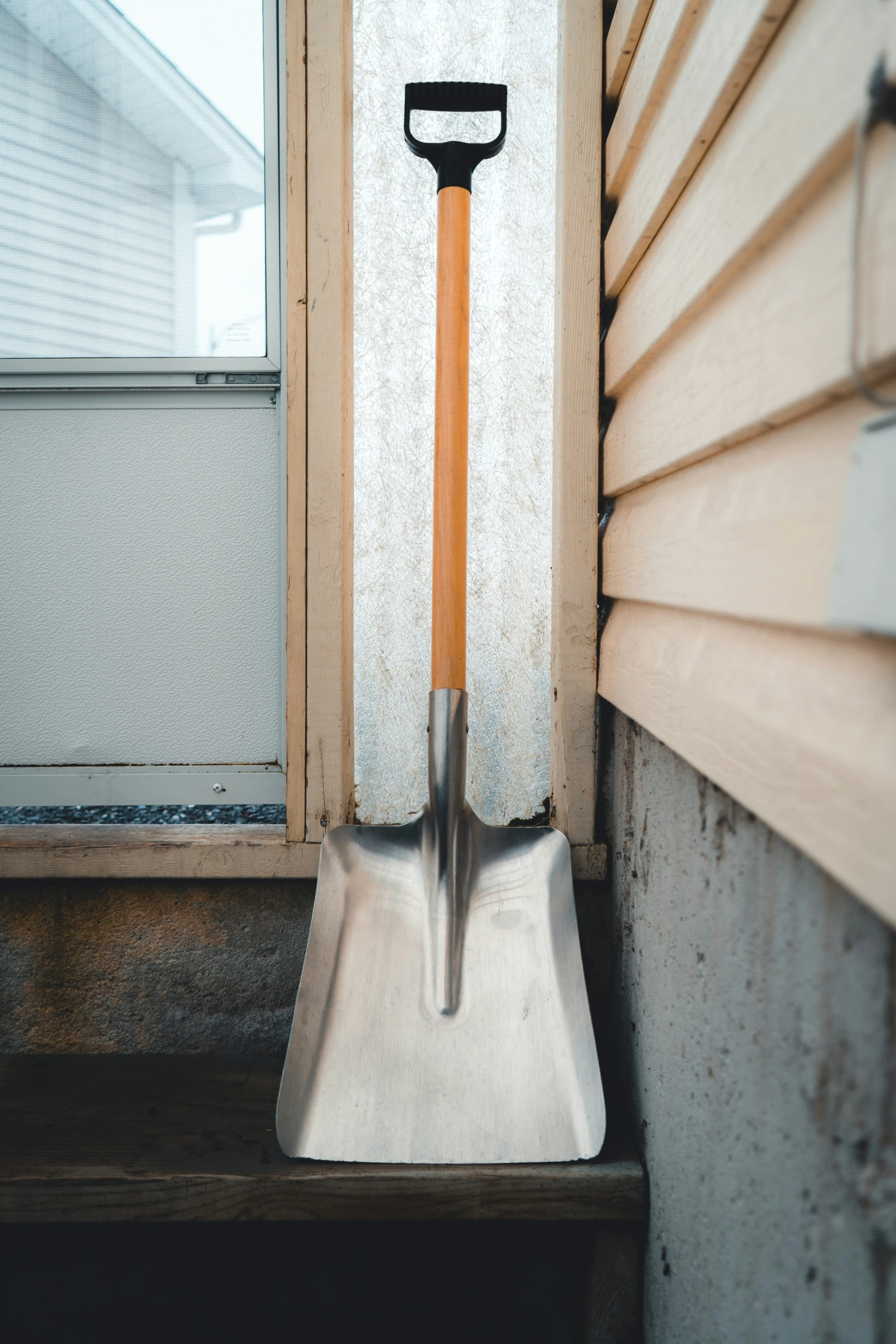 a shovel sticking out of a window sill