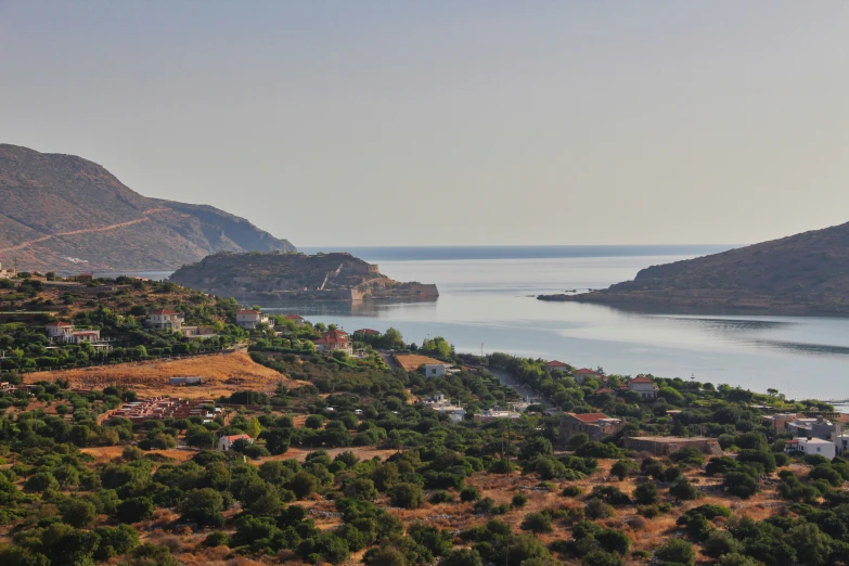 a view of some large hills surrounding the ocean