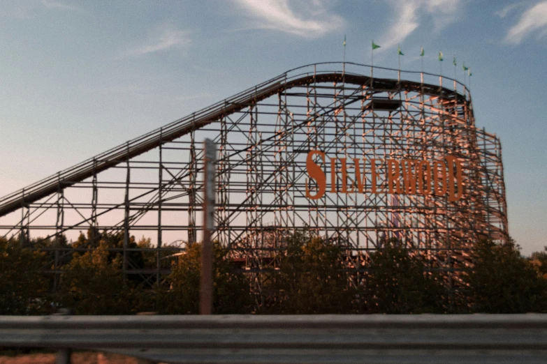 a roller coaster for an amut park on a sunny day