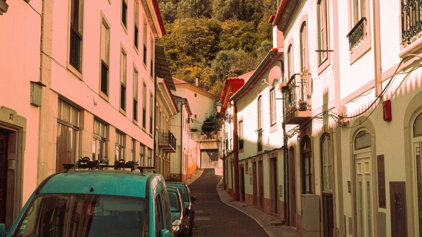 an old and worn down street with pink houses