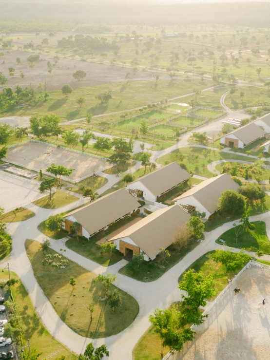 aerial view of buildings in green area near small lake