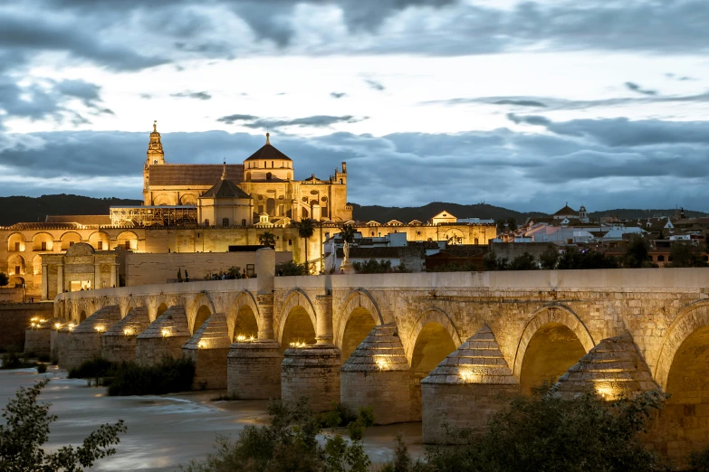 a bridge with a lit up city in the background